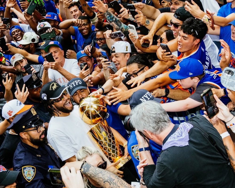 New York Knicks championship parade, fans celebrating with the Larry O'Brien trophy